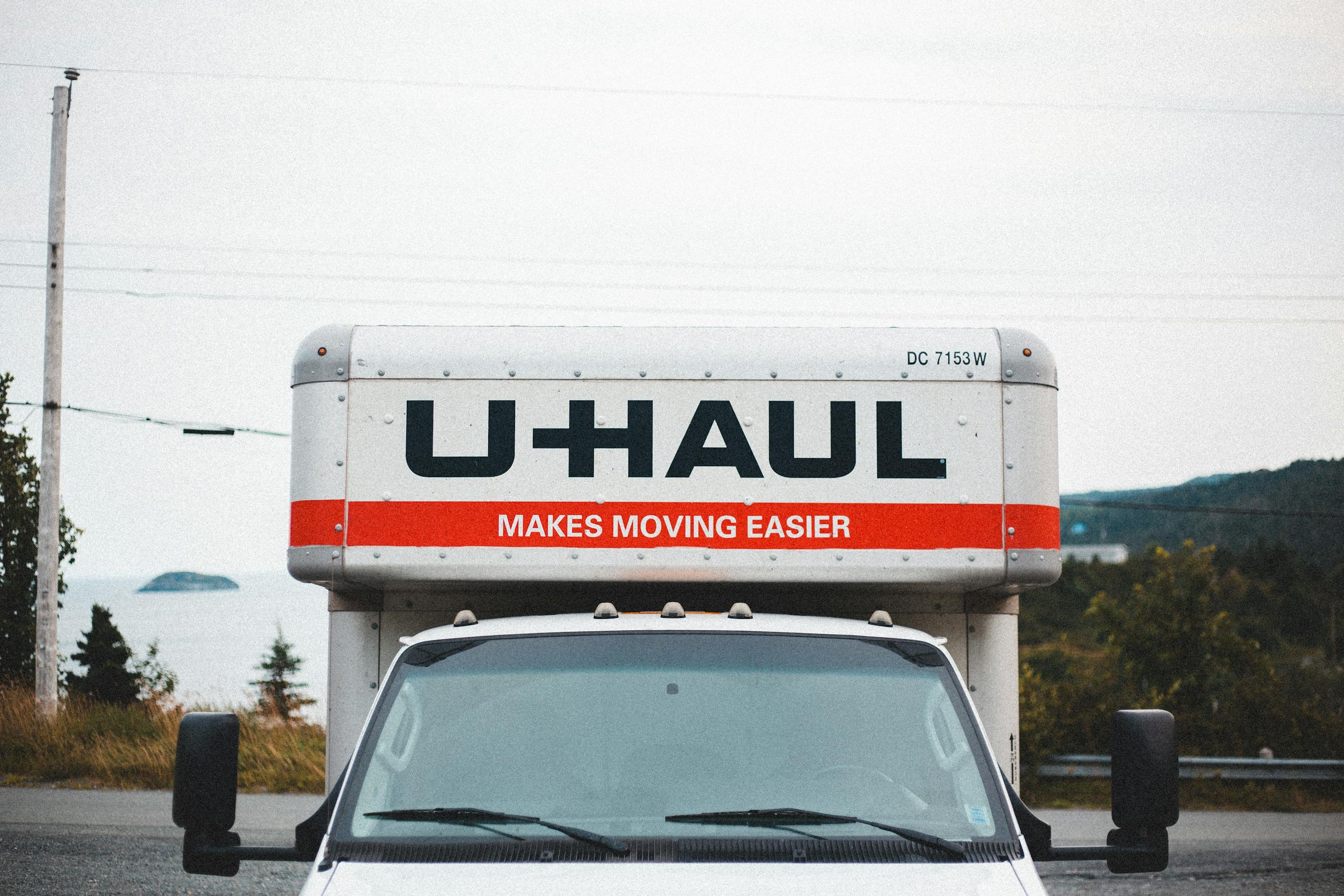 U-Haul moving truck parked on roadside with scenic outdoor backdrop.
